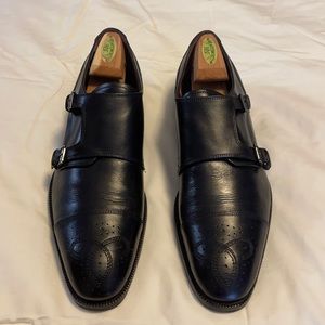 Black Double monk-strap shoe with brogue details.